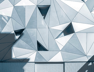 A photographic image of a wall manipulated with graphic illustrations of several geometric triangles.