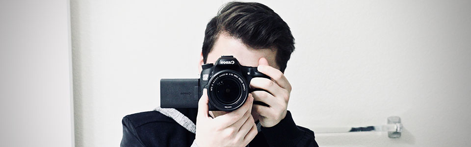 This image is of Jovanny Campos holding a canon camera taking a picture of himself.