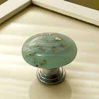 Picture of Celadon knob on nickle base on drawer front.