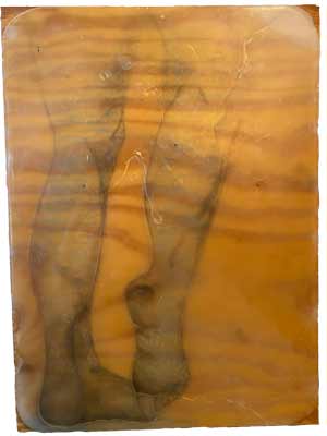 Wood board with blue human legs drawn on it, covered in clear wax, and legs recarved in the wax.