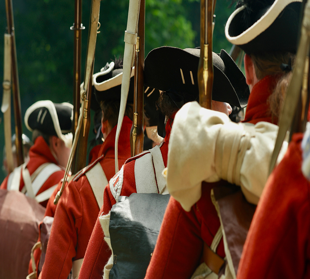 British Revolutionary War re-enactors marching in single-file line