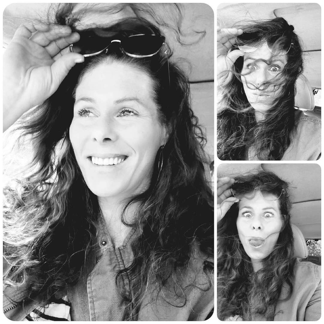 girl smiling with sunglasses on her head