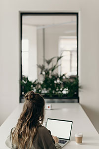Girl sitting at table with her laptop