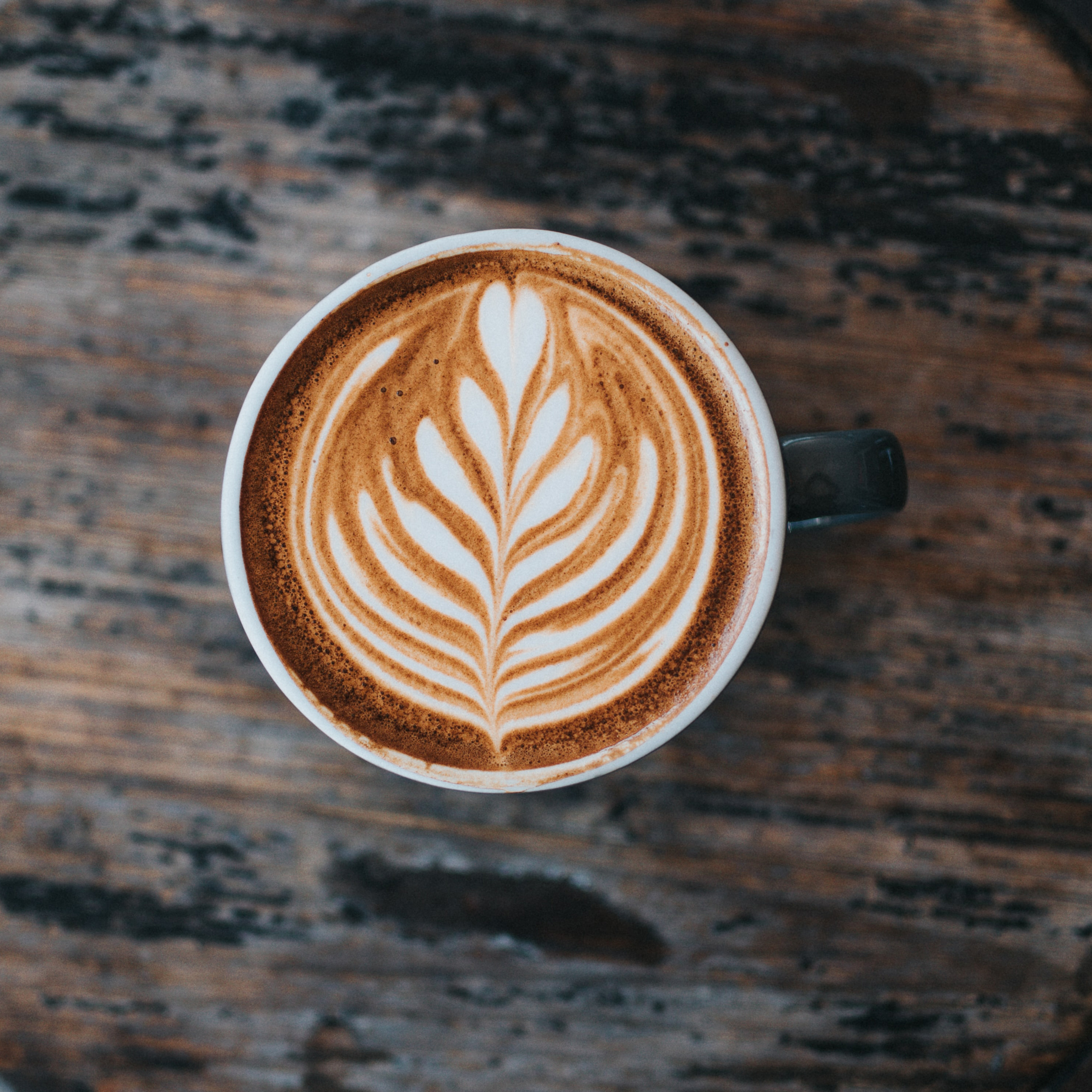 A cup of latte in a wooden table