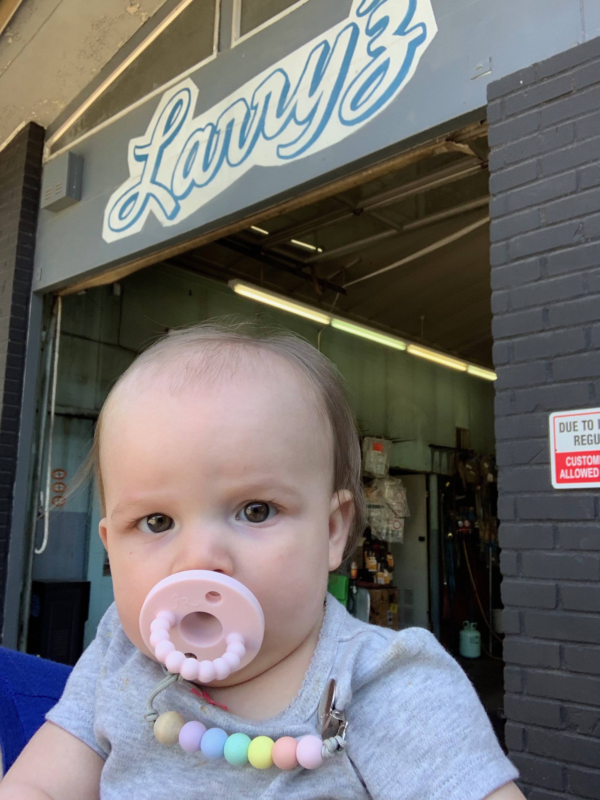 baby in front of shop