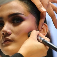 woman applying blush