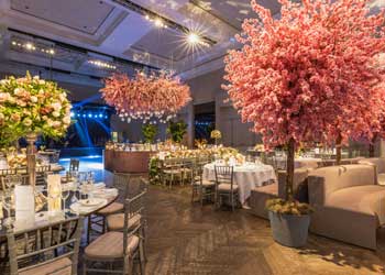 indoor event with fancy table settings and trees